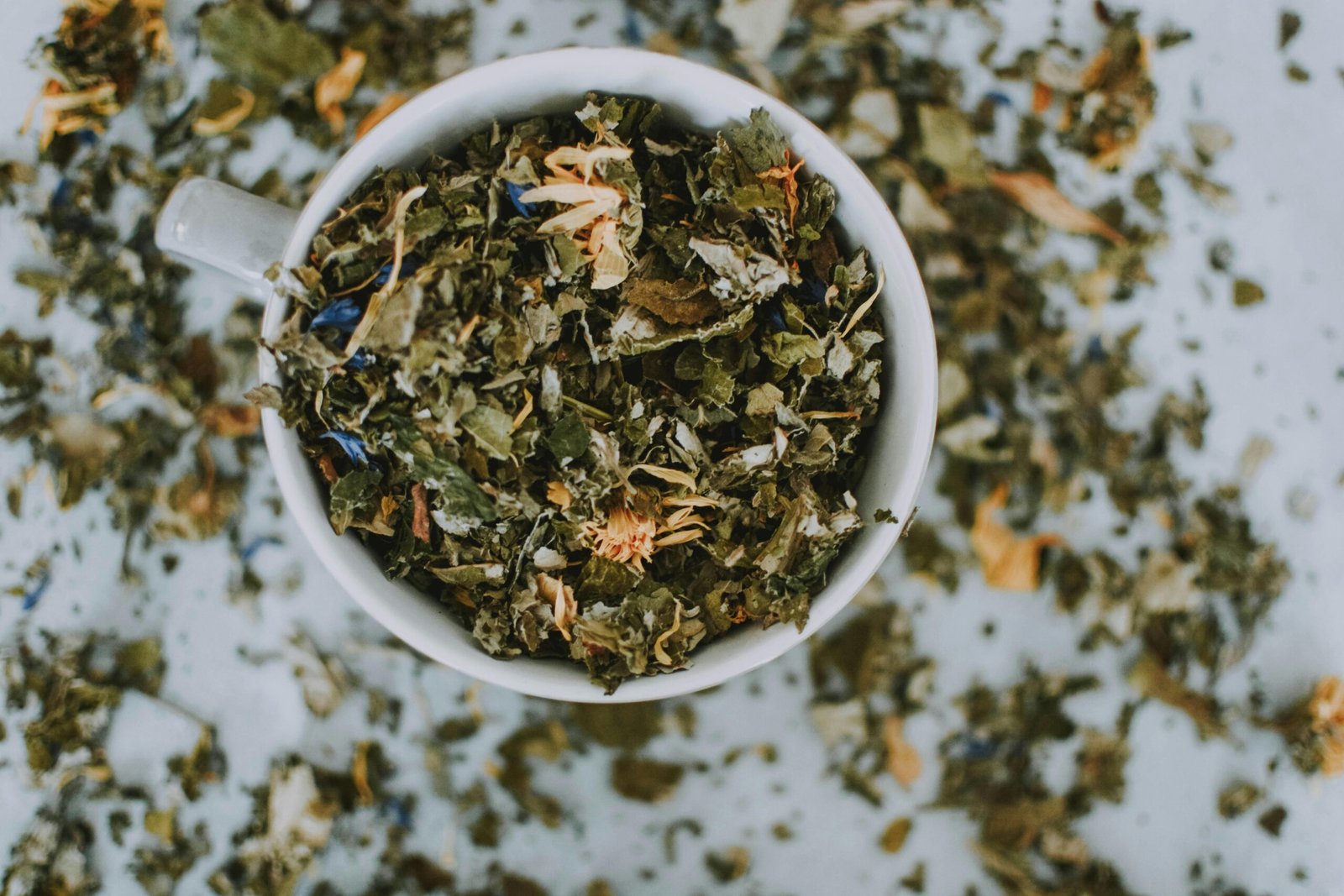 pexels-photo-1793035-1793035 Overhead shot of a cup with a blend of dried herbal tea leaves and flowers.